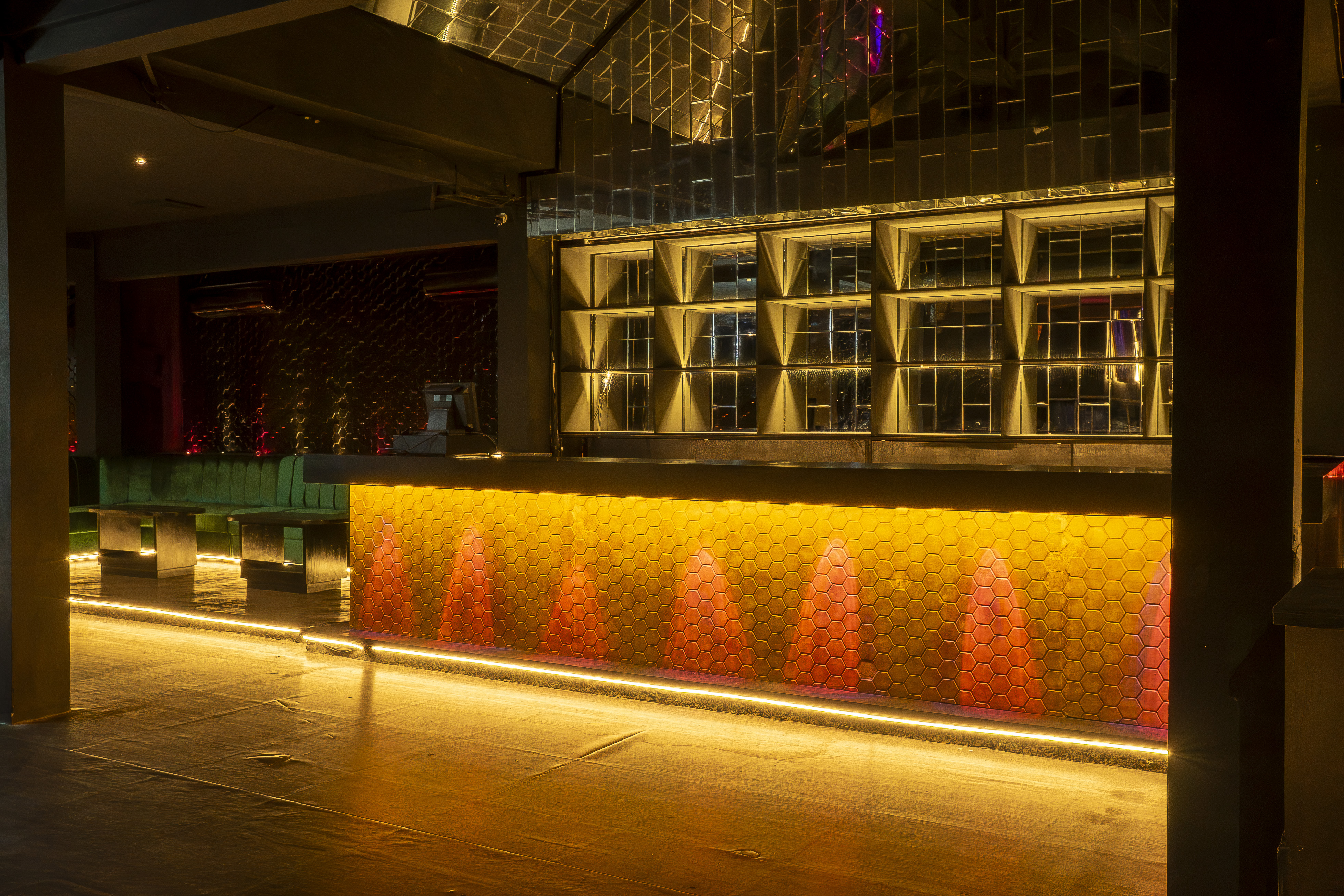 Bar area with backlit bottle shelving and honeycomb design